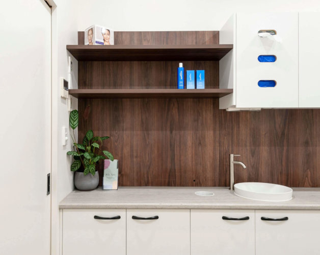 Bathroom with A White Sink and Wooden Shelves