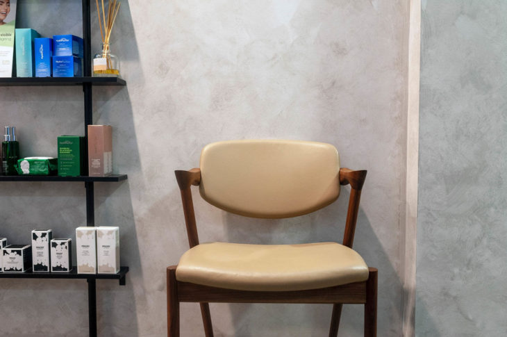 Brown Chair besides Shelves of Cosmetics