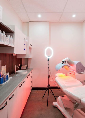 Clinic Chair and Ambient Lighting with Specialised Equipment and Cosmetics on the Shelves