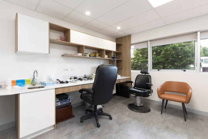 McCullough Centre - Office area featuring a blend of modern urban styling, varied chairs, and wooden interior shelves, creating a refined and comfortable workspace