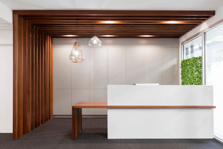 McCullough Centre - Sleek Wooden Interior Design with White Counter and Falling Ceiling Lamp