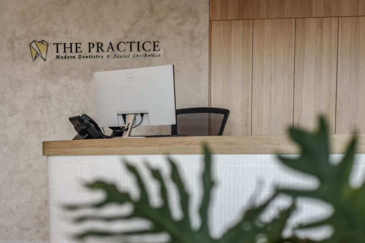 A Reception Desk with the Practice Logo on It