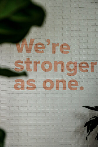 Technology One Brisbane - Motivational quote 'We Are Stronger As One' displayed on the wall of Technology One Gym, inspiring unity and wellness among employees