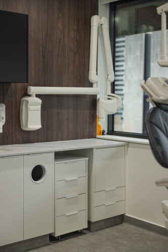 A Sophisticated Dentist's Office Featuring a Wall-Mounted TV and Specialized Equipment