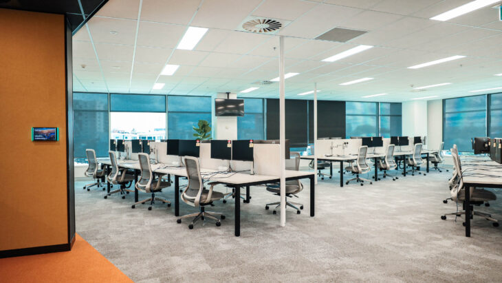 Open-plan office layout by Consilo at TechnologyOne, crafted for flexibility and team interaction. Modern office interior with sleek furniture and bright lighting
